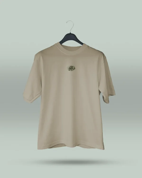 Camiseta beige unisex con ilustración artística de flores en círculo y la frase inspiradora Eres lo que te repites. Diseño exclusivo creado por ilustrador colombiano, ideal para quienes buscan ropa original con mensajes motivadores. Disponible en tallas varias y con envíos a todo Colombia.
